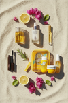 Holiday beauty bag flat lay with luxury travel size skincare and beauty products — Oh So Luxe